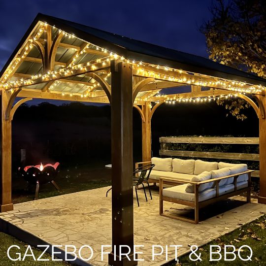 A gazebo with fairy lights and with lounge seating at a large firepit at Stockman's Ridge Wines